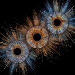 Luxurious "Iris Photography" artwork: three human eye irises (brown, grey-blue, yellowish-brown) surrounded by a powerful stardust explosion in gold and bluish tones against a black background. This is unique iris art online, transforming the beauty of your eyes into a majestic legacy. The online iris service allows you to order such personalized artworks online.