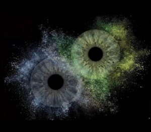 Mystical "Iris Art online" piece "Hidden Galaxy": two human eye irises (blue and brown) surrounded by a powerful blue and yellowish dust cloud effect on a black background. This meaningful piece is part of the iris art online collection, symbolizing hidden soul harmony. Order your online iris scan now.