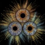 Powerful "Iris Art online" artwork: three human eye irises (grey-blue, yellowish, brown) joined by a powerful blue and yellowish dust explosion effect against a black background. This is unique iris art online, transforming the beauty of your eyes into an energetic and colorful masterpiece. The online iris service allows you to order such personalized artworks online.