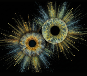 Vivid "Iris Photography" artwork "Supernova Souls": two human eye irises (blue and amber) surrounded by a powerful, colorful dust and light explosion effect on a black background. This is unique iris art online, transforming the beauty of your eyes into a cosmic masterpiece. The online iris service allows you to order such personalized artworks online.