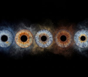 Custom matched iris art photography featuring five human eye irises aligned horizontally against a deep black background. The unique detailed iris patterns include cool blue, deep brown, hazel, and green irises, each surrounded by a customized explosion of fine stardust particles and colored dust transitions from blue to copper and gold. The surrounding cosmic dust colors are personalized to match the natural pigments within each specific iris. This high-end bespoke wall art print visualizes a profound family bond or friendship connection, suitable for a personalized, atmospheric home decor gallery.