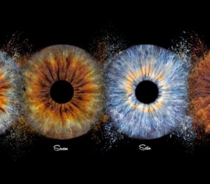 Personalized "Iris Art online" piece: four distinct human eye irises arranged horizontally on a black background. Each eye is integrated into a glowing swirl of stars and cosmic nebulae, creating a sense of infinity and grandeur. This meaningful piece is part of the iris art online collection, perfect for highlighting the spiritual bond between loved ones. Order your online iris scan now.