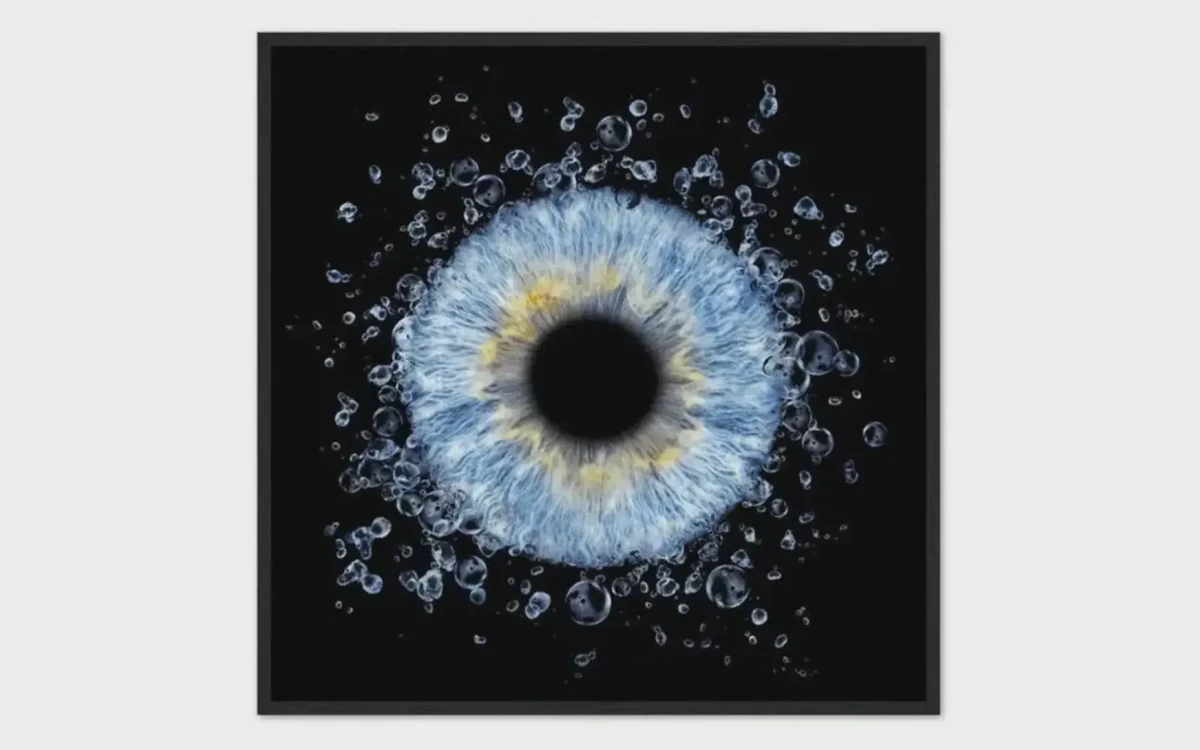 Ocean Spark personalized single iris photography artwork featuring one real blue eye iris surrounded by water splash effects on black.