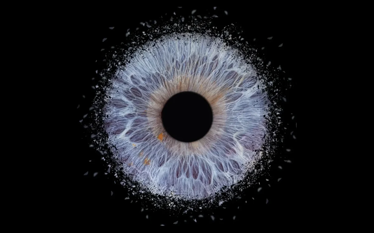 Soft Eclipse custom single eye art featuring one real iris in soft blue and lavender tones with delicate glowing details on a black background.